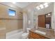 Bathroom featuring tiled shower-over-tub, granite vanity, toilet and window at 8821 N 9Th Ave, Phoenix, AZ 85021