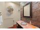 Unique powder room featuring a vessel sink, stone wall, and decorative metal accents at 8821 N 9Th Ave, Phoenix, AZ 85021