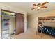 Bright bedroom features a ceiling fan, bunk beds with decorative bedspreads, and a closet with wooden door at 8821 N 9Th Ave, Phoenix, AZ 85021
