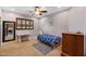 Cozy bedroom with a small metal-framed bed, desk, rug, and ceiling fan at 8821 N 9Th Ave, Phoenix, AZ 85021