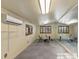 A spacious workout room with mirror accent wall, exercise equipment, and a window with wooden shutters at 8821 N 9Th Ave, Phoenix, AZ 85021