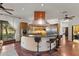 Gourmet kitchen with a large island, stainless steel appliances, custom cabinetry, and a unique copper range hood at 8821 N 9Th Ave, Phoenix, AZ 85021