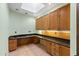 Bright office space featuring custom wood cabinets, granite countertops, a skylight, and light green paint at 8821 N 9Th Ave, Phoenix, AZ 85021