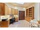 A home office featuring built-in bookshelves, a desk, and wood cabinets with a rolling office chair at 8821 N 9Th Ave, Phoenix, AZ 85021