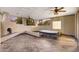 A large covered patio with a fireplace, a hot tub, and an outdoor ceiling fan at 8821 N 9Th Ave, Phoenix, AZ 85021