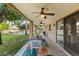 Covered patio with ceiling fans, dining table, and view of the backyard and pool at 8821 N 9Th Ave, Phoenix, AZ 85021