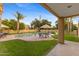 Inviting backyard pool area with lush greenery, patio seating, and palm trees at 8821 N 9Th Ave, Phoenix, AZ 85021