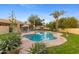 Beautiful backyard with a kidney-shaped pool, patio furniture, and mature trees at 8821 N 9Th Ave, Phoenix, AZ 85021