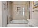 Close-up of a tiled shower stall featuring a built-in niche for toiletries and clear glass doors at 9100 E Raintree Dr # 115, Scottsdale, AZ 85260