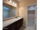 Bathroom featuring granite countertops, dark wood cabinets, and a walk-in closet at 9408 W Jackson St, Tolleson, AZ 85353