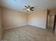 Spacious bedroom with neutral walls, a ceiling fan, and tile flooring for a clean, modern look at 9408 W Jackson St, Tolleson, AZ 85353