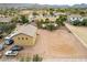 Aerial view featuring a large backyard, detached garage, pool, and surrounding desert landscape at 9768 W Prospector Dr, Queen Creek, AZ 85144