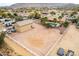 Aerial view featuring a large backyard, detached garage, pool, and surrounding desert landscape at 9768 W Prospector Dr, Queen Creek, AZ 85144