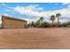 Spacious backyard featuring desert landscaping, detached garage, and a charming single-story home at 9768 W Prospector Dr, Queen Creek, AZ 85144