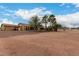 Expansive backyard featuring desert landscaping, mature trees, and a charming single-story home at 9768 W Prospector Dr, Queen Creek, AZ 85144