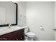 Half bathroom with a dark wood vanity, white sink, and modern fixtures at 9768 W Prospector Dr, Queen Creek, AZ 85144