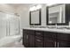 Bathroom featuring dual sinks, modern fixtures, and a shower with glass door at 9768 W Prospector Dr, Queen Creek, AZ 85144