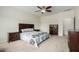 Bedroom with neutral carpet, ceiling fan, stylish furnishings, and natural light at 9768 W Prospector Dr, Queen Creek, AZ 85144
