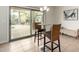 Bright dining area with a modern chandelier and sliding glass doors leading to the outdoor pool at 9768 W Prospector Dr, Queen Creek, AZ 85144