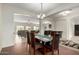 Elegant dining room with archways, tile flooring, and stylish decor open to the living room at 9768 W Prospector Dr, Queen Creek, AZ 85144