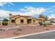 Inviting single-story home with a well-maintained yard, desert landscaping, and a spacious driveway at 9768 W Prospector Dr, Queen Creek, AZ 85144