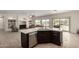 Open-concept kitchen with granite island, stainless steel appliances, and a view to the living area at 9768 W Prospector Dr, Queen Creek, AZ 85144