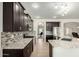 Gourmet kitchen featuring dark wood cabinets, granite countertops, and stainless steel appliances at 9768 W Prospector Dr, Queen Creek, AZ 85144