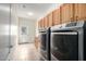 Laundry room featuring modern washer and dryer, cabinet space, and access to the backyard at 9768 W Prospector Dr, Queen Creek, AZ 85144