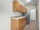 Well-equipped laundry room with ample cabinet space, a sink, and modern appliances at 9768 W Prospector Dr, Queen Creek, AZ 85144