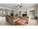 Spacious living room with tile floors, comfortable seating, and built-in shelving at 9768 W Prospector Dr, Queen Creek, AZ 85144