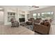 Cozy living room featuring built-in shelves and large windows offering plenty of natural light at 9768 W Prospector Dr, Queen Creek, AZ 85144