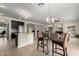 Open-concept living space with a kitchen island, bar seating, and living room with fireplace at 9768 W Prospector Dr, Queen Creek, AZ 85144