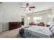 Bedroom featuring a ceiling fan, plush carpet, and a view to ensuite bathroom at 9768 W Prospector Dr, Queen Creek, AZ 85144