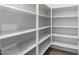 Walk-in pantry with built-in shelving for ample storage at 9768 W Prospector Dr, Queen Creek, AZ 85144