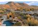 Scenic aerial view of desert homes nestled amidst lush vegetation with a pool at 11617 E Raintree Dr, Scottsdale, AZ 85255
