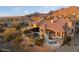 Aerial view of a home and backyard pool surrounded by a white fence and the desert landscape at 11617 E Raintree Dr, Scottsdale, AZ 85255