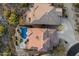 Aerial view of a property showcasing a backyard pool, patio, and lush desert landscaping at 11617 E Raintree Dr, Scottsdale, AZ 85255