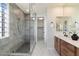 Modern bathroom featuring a glass enclosed shower, granite vanity, and white marbled floors at 11617 E Raintree Dr, Scottsdale, AZ 85255