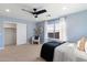 Well-lit bedroom showcasing a walk-in closet, a large window, and a ceiling fan at 11617 E Raintree Dr, Scottsdale, AZ 85255