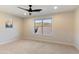 Bedroom with neutral walls, a window overlooking the mountains, and carpeted floors at 11617 E Raintree Dr, Scottsdale, AZ 85255