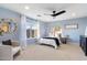 Bright bedroom featuring a ceiling fan, a large window, and neutral carpeting at 11617 E Raintree Dr, Scottsdale, AZ 85255