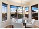 Cozy breakfast nook surrounded by large windows, providing scenic views and natural light for a pleasant dining experience at 11617 E Raintree Dr, Scottsdale, AZ 85255