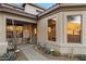 Charming front exterior with desert landscaping, walkway, and covered porch with stylish seating at 11617 E Raintree Dr, Scottsdale, AZ 85255