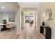 Open hallway featuring hardwood floors, leading to living spaces with stylish decor and natural light at 11617 E Raintree Dr, Scottsdale, AZ 85255