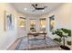 Well-lit home office with multiple windows, a wooden desk, and desert views at 11617 E Raintree Dr, Scottsdale, AZ 85255