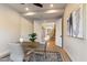 Well-lit office with a view to the stairs, complete with wooden floors and a modern chair at 11617 E Raintree Dr, Scottsdale, AZ 85255