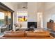 Bright living room with a fireplace, view of the backyard, and comfortable seating at 11617 E Raintree Dr, Scottsdale, AZ 85255