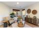 Comfortable living room features designer furnishings, bright windows, and stylish decorative elements at 11617 E Raintree Dr, Scottsdale, AZ 85255