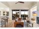 Spacious living room with a seamless transition to the outdoor patio, featuring a comfortable seating area and a modern ceiling fan at 11617 E Raintree Dr, Scottsdale, AZ 85255