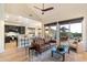 Open-concept living room with a high ceiling, hardwood floors, and seamless access to the outdoor patio at 11617 E Raintree Dr, Scottsdale, AZ 85255